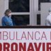 Members of the University Clinical Center of Kosovo in protective gear walk past a sign reading "Ambulance For Coronavirus" at the University Clinical Center of Kosovo in Pristina on March 14, 2020. - Kosovo reported its first coronavirus (COVID-19) case on March 13, 2020, in a 22-year-old Italian woman and a 77-year-old Kosovar man, both recently returned from Italy. (Photo by Armend NIMANI / AFP)