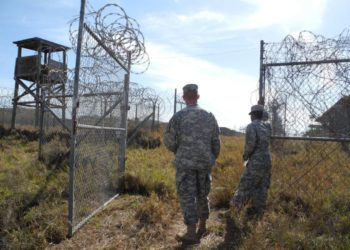 epa03836451 US Sergeants Cody Stagner (L) and Lerone Simmons on the grounds of the now closed Camp X-Ray in Guantanamo Bay, Cuba, 22 August 2013. The Guantanamo Bay detention camp is a controversial United States military prison located within Guantanamo Bay Naval Base, Cuba that was established in January 2002.  EPA/Johannes Schmitt-Tegge No data!