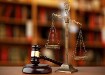 Gavel And Scales Of Justice On Desk In Law Office