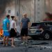 People react near a fire after rockets were launched from the Gaza Strip, in Ashkelon, Israel October 7, 2023. REUTERS/Amir Cohen