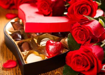 Heart shaped box of chocolate truffles with red roses