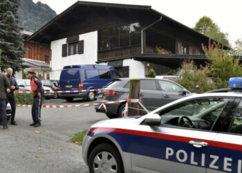 A police car is parked in front of a house in Kitzbuehl, Austria, Sunday, Oct. 6, 2019. Austrian police say a 25-year-old man's in custody after allegedly killing his ex-girlfriend, her family, and her new boyfriend in the Alpine resort town of Kitzbuehel. The 25-year-old turned himself to police in the town east of Innsbruck and admitted to the five slayings early Sunday morning, Austrian news agency APA reported. (AP Photo/Kerstin Joensson)