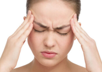 Beautiful young woman with headache touching her temples, isolated in white