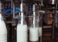 filling milk in to plastic bottles at the factory. equipment at the dairy plant
