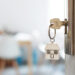 Key with keychain in a house shape in the door keyhole. Buy new home concept. Real estate market.