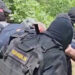 Serbian security forces detain Kosovo police officers in a location given as near Gnjilica, Serbia June 14, 2023 in this screengrab obtained from a handout video. MINISTRY OF INTERNAL AFFAIRS OF SERBIA/via REUTERS  THIS IMAGE HAS BEEN SUPPLIED BY A THIRD PARTY. MANDATORY CREDIT. NO RESALES. NO ARCHIVES. REUTERS WAS NOT ABLE TO INDEPENDENTLY VERIFY THE LOCATION OF THE VIDEO