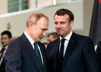 BERLIN, GERMANY - JANUARY 19: French President Emmanuel Macron (R) and Russian President Vladimir Putin (L) arrive for a family picture at the Chancellery on January 19, 2020 in Berlin, Germany. Leaders of nations and organizations linked to the current conflict are meeting to discuss measures towards reaching a consensus between the warring sides and ending hostilities. (Photo by Emmanuele Contini/Getty Images)