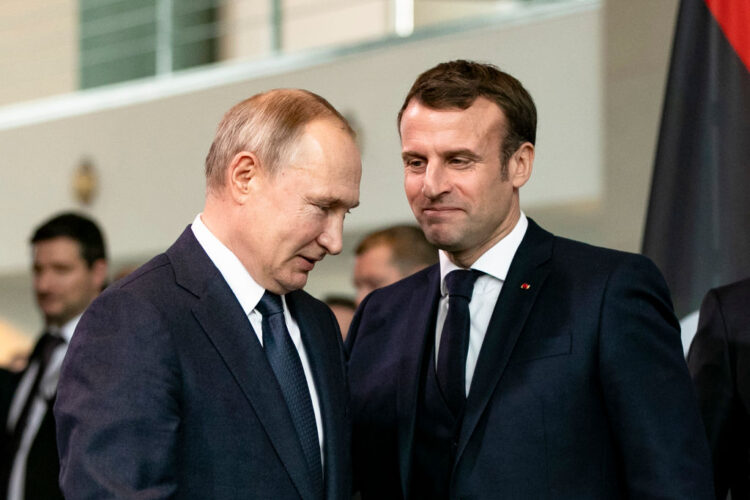 BERLIN, GERMANY - JANUARY 19: French President Emmanuel Macron (R) and Russian President Vladimir Putin (L) arrive for a family picture at the Chancellery on January 19, 2020 in Berlin, Germany. Leaders of nations and organizations linked to the current conflict are meeting to discuss measures towards reaching a consensus between the warring sides and ending hostilities. (Photo by Emmanuele Contini/Getty Images)