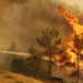 A firefighter extinguishes a forest fire near the town of Manavgat, east of the resort city of Antalya, Turkey, July 30, 2021. REUTERS/Kaan Soyturk