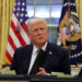 FILE PHOTO: U.S. President Donald Trump signs documents as he issues executive orders and pardons for Jan. 6 defendants in the Oval Office at the White House on Inauguration Day in Washington, U.S., January 20, 2025. REUTERS/Carlos Barria/File Photo