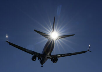 A Southwest plane flies low over Gravelly Point on approach to Ronald Reagan Washington National Airport in Arlington, Va., Friday, Dec. 30, 2022. The airline returned to a relatively normal flight schedule Friday, as the focus shifts to making things right with what could be well more than a million passengers who missed family connections or flights home during the holidays, and many of whom are still missing luggage. (AP Photo/Carolyn Kaster)