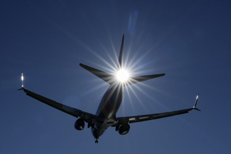 A Southwest plane flies low over Gravelly Point on approach to Ronald Reagan Washington National Airport in Arlington, Va., Friday, Dec. 30, 2022. The airline returned to a relatively normal flight schedule Friday, as the focus shifts to making things right with what could be well more than a million passengers who missed family connections or flights home during the holidays, and many of whom are still missing luggage. (AP Photo/Carolyn Kaster)
