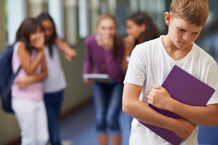 A young boy being bullied at school