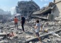 Palestinians inspect the damage following an Israeli airstrike on the El-Remal aera in Gaza City on October 9, 2023. Israel continued to battle Hamas fighters on October 10 and massed tens of thousands of troops and heavy armour around the Gaza Strip after vowing a massive blow over the Palestinian militants' surprise attack. Photo by Naaman Omar apaimages