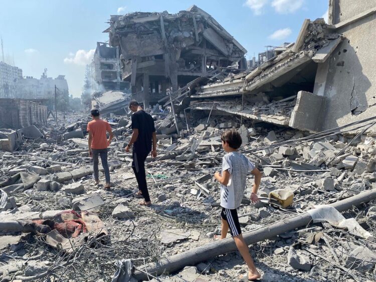 Palestinians inspect the damage following an Israeli airstrike on the El-Remal aera in Gaza City on October 9, 2023. Israel continued to battle Hamas fighters on October 10 and massed tens of thousands of troops and heavy armour around the Gaza Strip after vowing a massive blow over the Palestinian militants' surprise attack. Photo by Naaman Omar apaimages